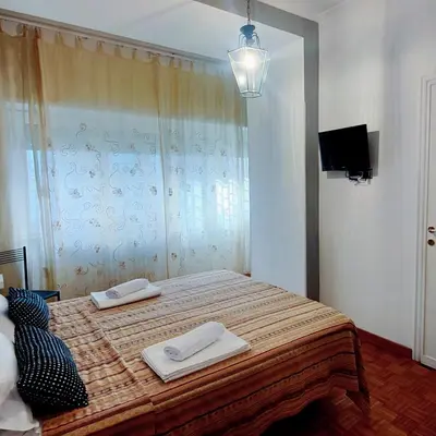 a bedroom with a bed with two towels on it at Roma For You - Apartment - Metro B in Rome