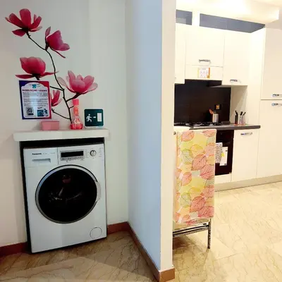 a kitchen with a washing machine in a room at Roma For You - Apartment - Metro B in Rome