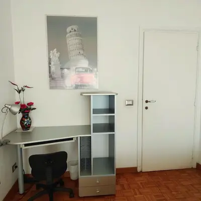 a desk and a chair in a room at Roma For You - Apartment - Metro B in Rome