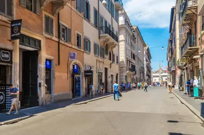 a group of people riding skateboards down a city street at Piazza di Spagna Luxury Apartment in Rome