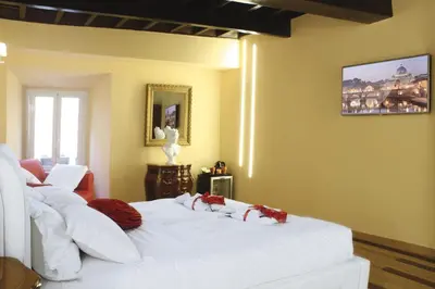 a bedroom with a large white bed with two dogs on it at Hub Navona in Rome