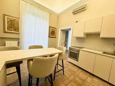 a kitchen with a table and chairs in a room at èROMA - SANTA MARIA MAGGIORE BASILICA Apartment in Rome