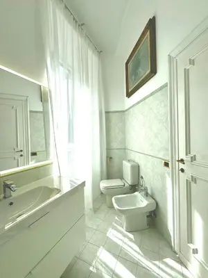 a white bathroom with a toilet and a sink at èROMA - SANTA MARIA MAGGIORE BASILICA Apartment in Rome