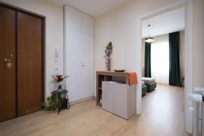 a living room with a couch and a television at San Giovanni Charming Suites in Rome