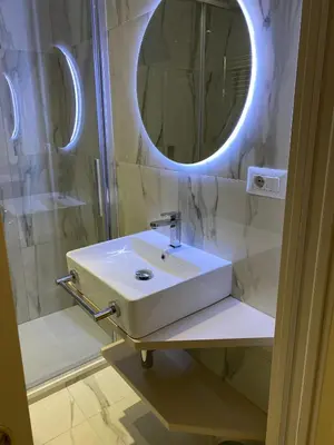 a bathroom with a white sink and a mirror at Cozy Luxury Room Pantheon in Rome