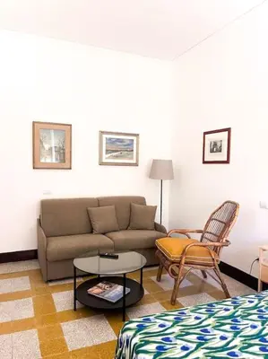 a living room with a couch and a table at Appartamento della Vittoria in Rome