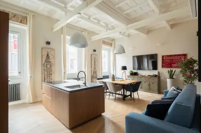 a kitchen and living room with a table and chairs at THE BREAK - Campo Marzio Maison Deluxe in Rome