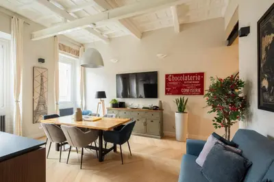 a dining room and living room with a table and chairs at THE BREAK - Campo Marzio Maison Deluxe in Rome