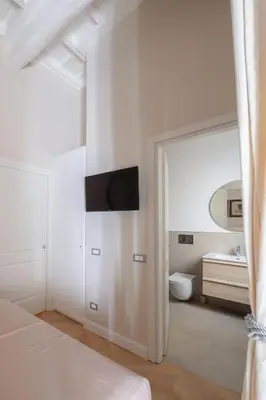 a white bedroom with a sink and a mirror at THE BREAK - Campo Marzio Maison Deluxe in Rome