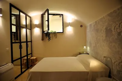 a bedroom with a white bed and a mirror at DomusLatina Monti - Luxury stay in the heart of Rome in Rome