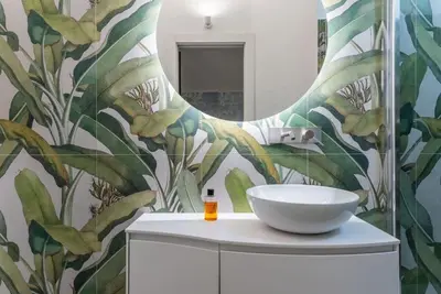 a bathroom with a white sink and a mirror at DomusLatina Monti - Luxury stay in the heart of Rome in Rome