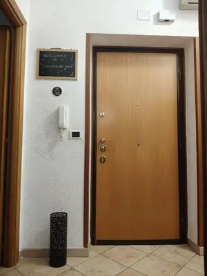 a wooden door in a room with a chalkboard on the wall at House For You in Rome