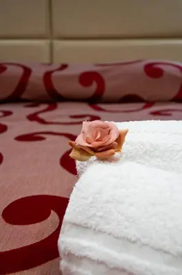 a bedroom with a large bed with a wooden headboard at MBS Marconi Bridge Suites Guest House in Rome