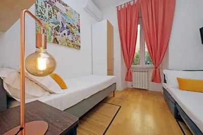 a living room with a white couch and red curtains at Apartment Vespucci in Rome