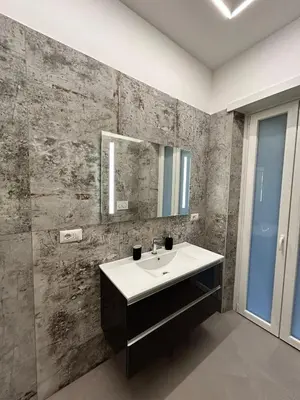 a bathroom with a sink and a mirror at Niva holiday house in Rome