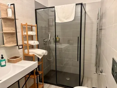a bathroom with a shower and a sink at Cozy Apartment with Metro Link to the Colosseum in Rome