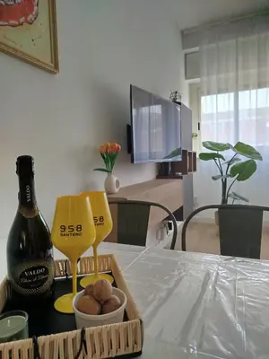 a bottle of wine sitting on a table next to a bottle of food at Dylan Apartment in Rome