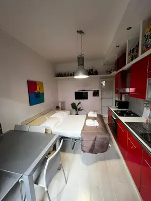 a kitchen with a table and a bed in a room at Procida's House by ACS HOLIDAYS in Rome