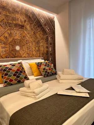 a large bed with towels on top of it at Suite dolce vita - san pietro in Rome