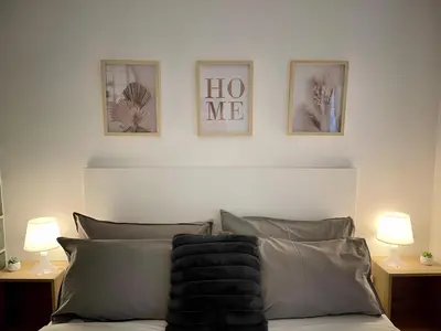 a bedroom with a bed with three pictures on the wall at Suite Mario - Colosseo in Rome