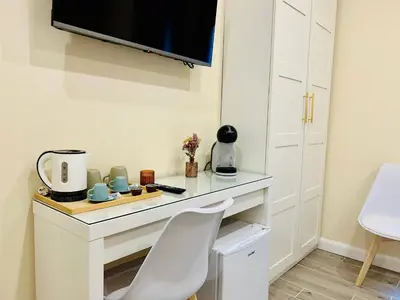 a white desk with a tv on a wall at Domus Altino in Rome