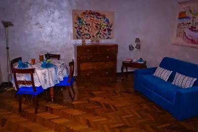 a living room with a table and a blue couch at La Casetta di Zio Mario in Rome