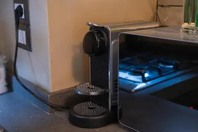 a microwave oven with a stove in a kitchen at Maison Campo De Fiori in Rome