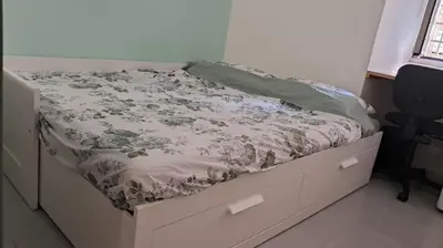 a bed in a bedroom with a bed frame with a blanket at Studio Salvia & Rosmarino in Rome