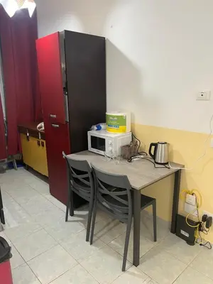a kitchen with a table with a microwave on it at SALENTINI APPARTAMENTo in Rome