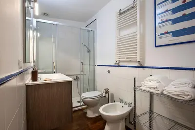 a bathroom with a toilet and a sink and a shower at Sant'Angelo Terrace Apartment in Rome