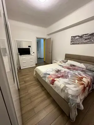 a bedroom with a bed and a dresser and a television at Roma nel Mondo in Rome