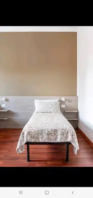 a bedroom with a bed with a white blanket on it at Cuore Di Roma Holidays in Rome