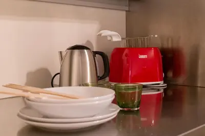 a table with plates and bowls and a coffee pot at iFlat Pantheon Elegant 3-bedroom Apartment in Rome