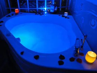 a blue bath tub with a candle and rocks in it at Jazz Style Home in Rome