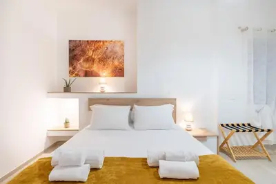 a bedroom with a large white bed with two pillows at Metro A 1 min - Casa Elegante - 3 bagni En Suite in Rome