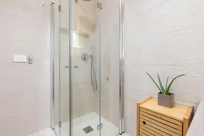 a shower stall in a bathroom with a potted plant at Metro A 1 min - Casa Elegante - 3 bagni En Suite in Rome