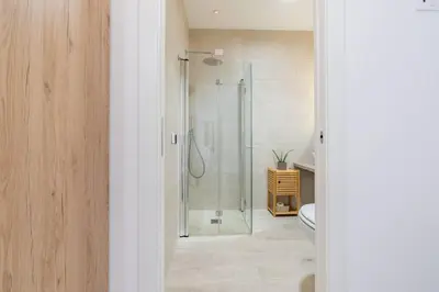 a bathroom with a glass shower with a toilet at Metro A 1 min - Casa Elegante - 3 bagni En Suite in Rome
