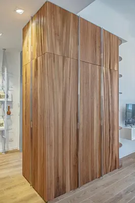 a large wooden cabinet in a room with wood floors at a casa di Manuela luxury apartment in Rome