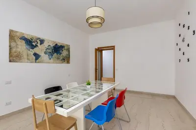a dining room with a glass table and chairs at Presidential Vatican Palace II in Rome