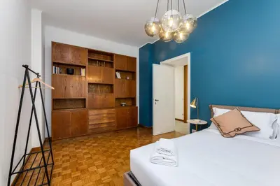 a room with a bed and a blue wall at Presidential Vatican Palace II in Rome