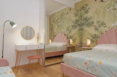 a bedroom with two beds and a mirror at Appia Holiday Home in Rome