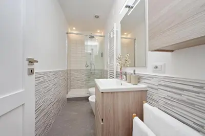 a bathroom with a sink and a toilet and a shower at Appia Holiday Home in Rome