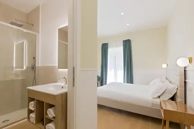 a bedroom with a bed and a sink and a mirror at Risorgimento 9 - Guest House in Rome