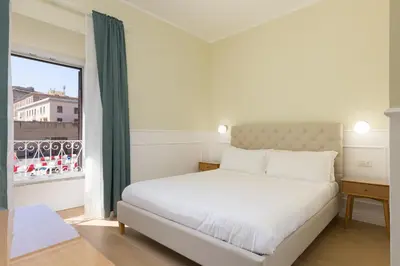 a bedroom with a white bed and a large window at Risorgimento 9 - Guest House in Rome