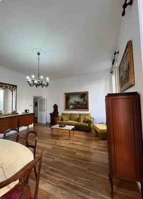 a living room with a couch and a table at Maison Leone IV 22 in Rome