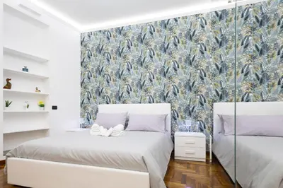 a bedroom with two beds and a wall mural at La Casa Di Alice in Rome
