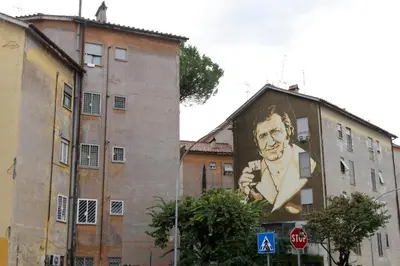 a large painting of a man on the side of a building at La Casa Di Alice in Rome