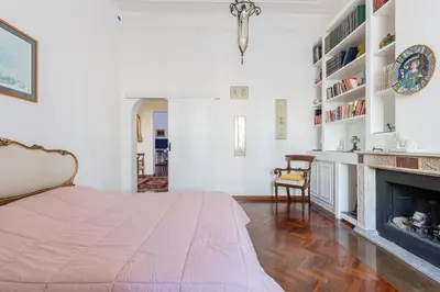 a bedroom with a bed and a fireplace at Rome Historic Center Stylehouse in Rome