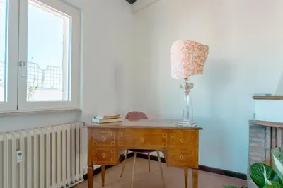 a desk with a lamp on it next to a window at Saint Peter's Luxury Terrace Suites in Rome