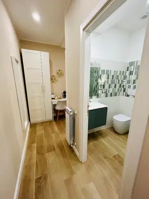 a bathroom with a toilet and a sink at Segesta Rooms in Rome